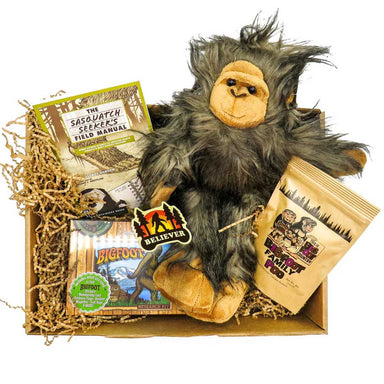 Sasquatch believer gift set that includes a bigfoot plush animal, bigfoot poop candy, a sticker, a field manual and a sasquatch research kit.