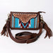 Brown leather crossbody bag with intricate design and tassels on a white background