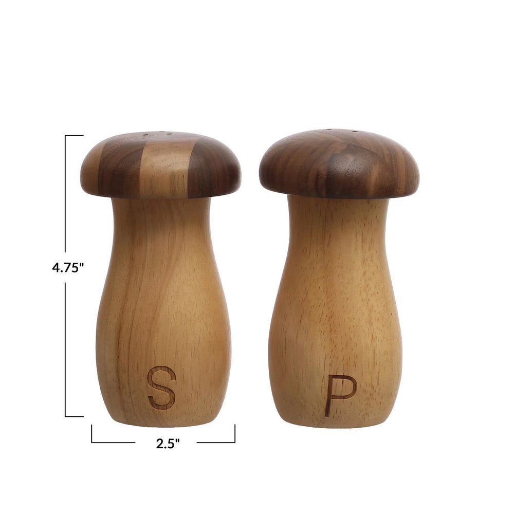 Wooden salt and pepper shakers with measurements on a white background