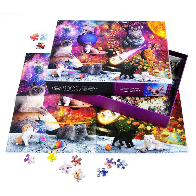 Jigsaw puzzle set with cat-themed pieces and box on a white background