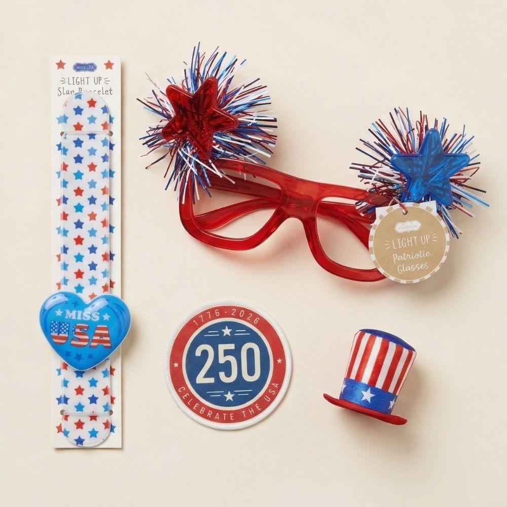 Collection of patriotic accessories including glasses, hat pin, and sticker on a beige background