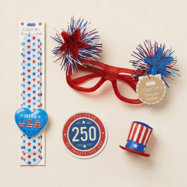 Collection of patriotic accessories including glasses, hat pin, and sticker on a beige background