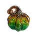 A hand-blown glass pumpkin ornament with a ribbed body, featuring a gradient of vibrant green at the bottom transitioning to amber-brown at the top, with a curled stem, shown on a plain white background.