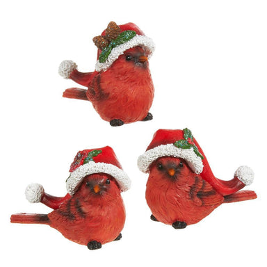 Three red bird figurines wearing festive hats on a white background