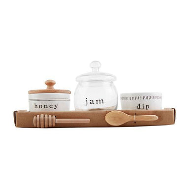 Set of ceramic jars labeled 'honey', 'jam', and 'dip' with wooden lids and spoons on a white background.