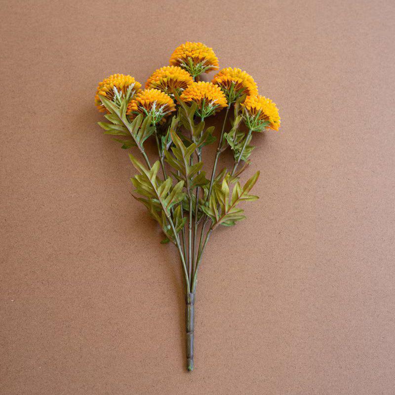 Bouquet of yellow flowers with green leaves on a brown background