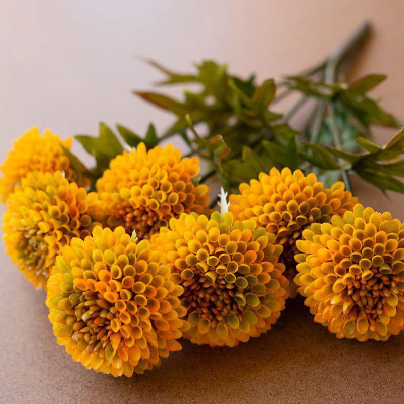 Bouquet of yellow flowers with green leaves on a neutral background