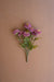 Bouquet of purple flowers on a brown background