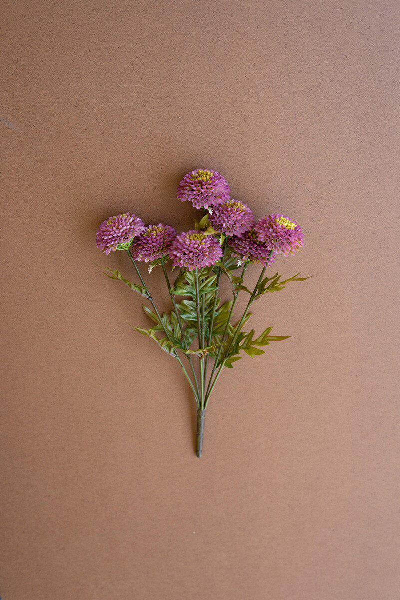Bouquet of purple flowers on a brown background