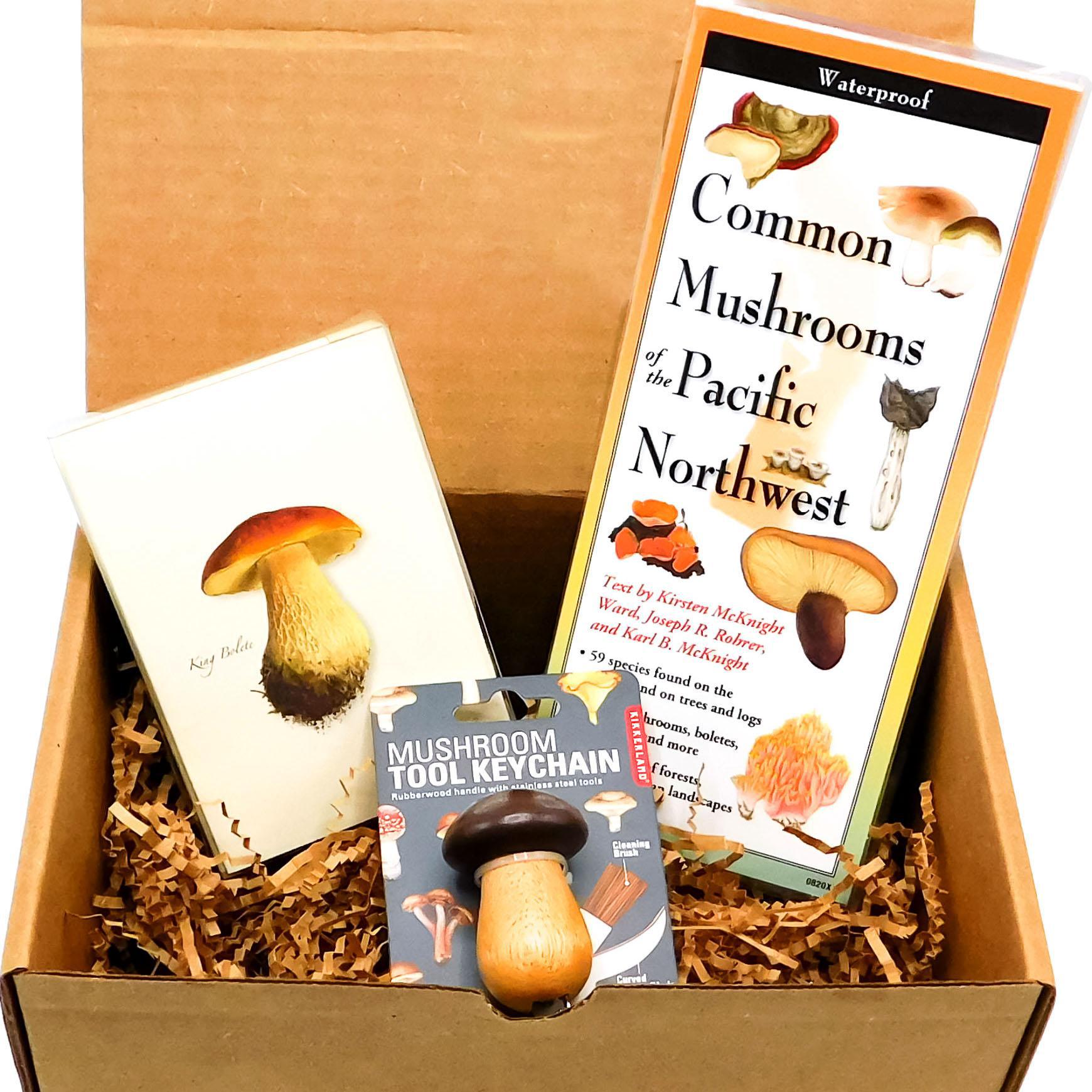fun box that includes a guide of common mushrooms from the Pacific Northwest, boxed blank notes with mushroom drawings, and a mushroom tool keychain