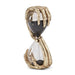 A decorative hourglass figurine featuring skeletal hands in a metallic gold finish holding a clear glass hourglass filled with dark sand, set against a plain white background.