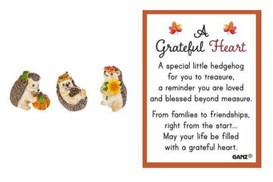 Decorative hedgehog figurines with a 'Grateful Heart' message on a white background