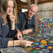 Two people working on a puzzle together in a rustic setting