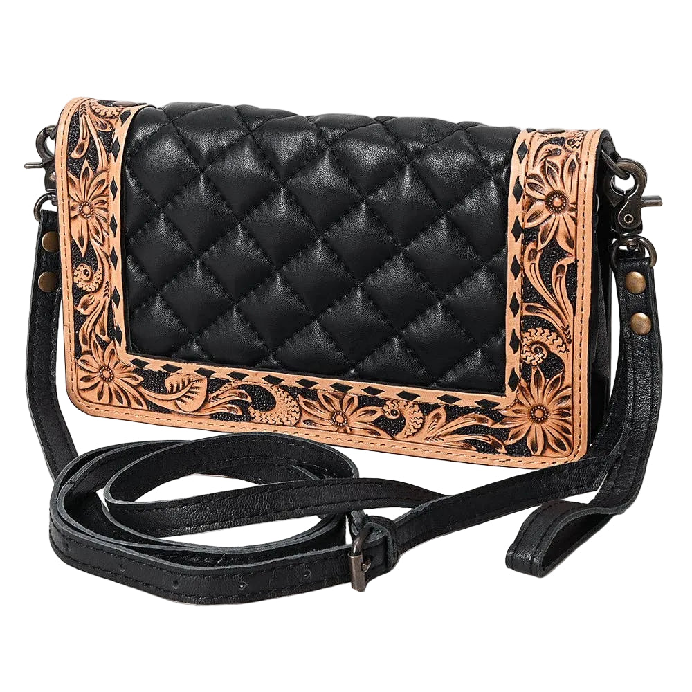 Black quilted leather crossbody bag with tan floral tooled leather borders, featuring a long adjustable black strap and dark metal hardware, shown on a plain white background.