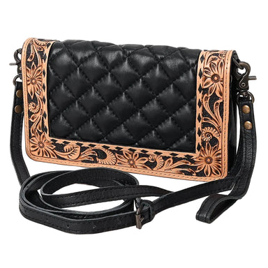 Black quilted leather crossbody bag with tan floral tooled leather borders, featuring a long adjustable black strap and dark metal hardware, shown on a plain white background.