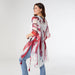 Woman wearing a red and white patterned kimono-style garment on a plain background