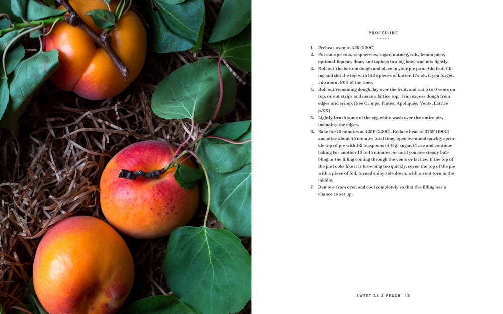 Book page with persimmons and green leaves on one side and text on the other
