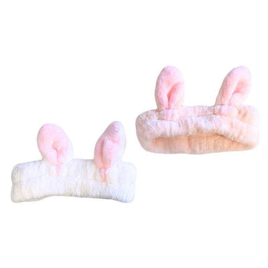 Two pairs of pink bunny ears on a white background