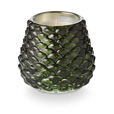 Green textured glass candle on a white background