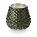 Green textured glass candle on a white background