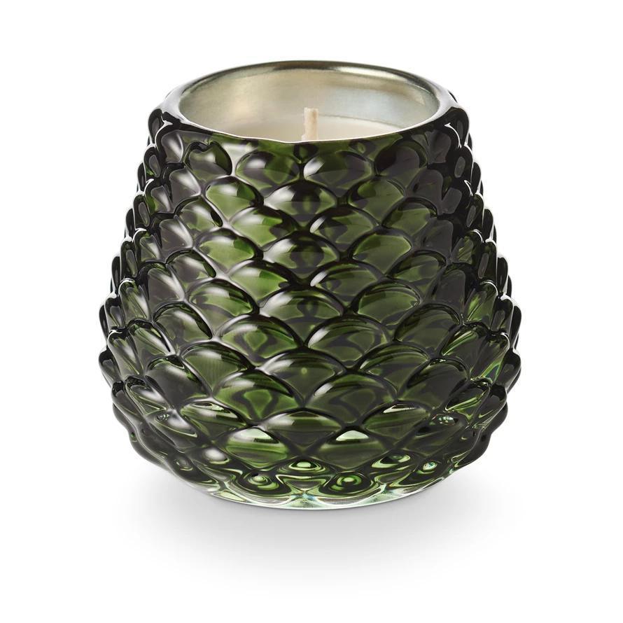 Green textured glass candle on a white background