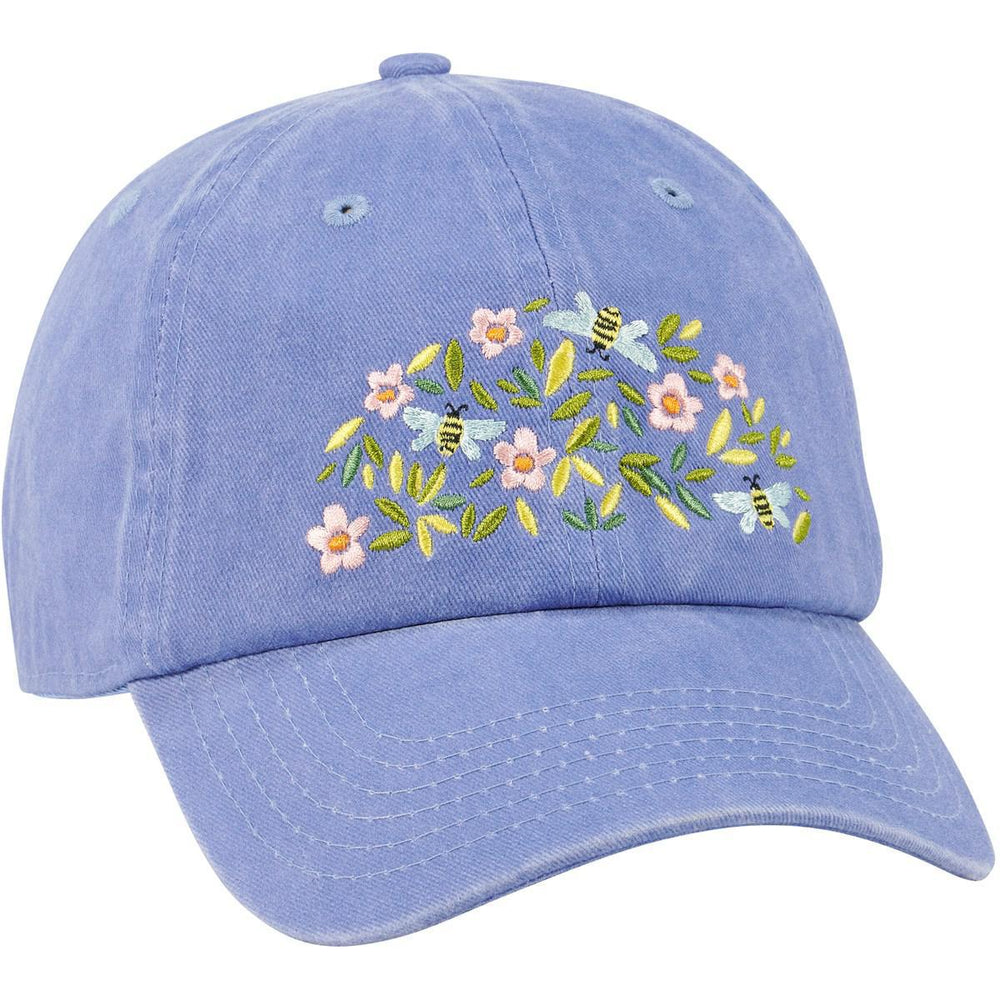 Blue cap with floral and bee embroidery on a white background