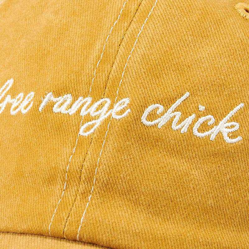 Yellow cap with 'free range chick' embroidery on a yellow background