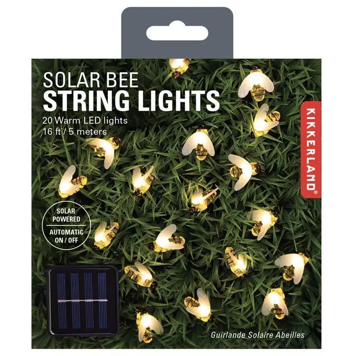 Packaging of solar bee string lights with Kikkerland branding on a grass background.