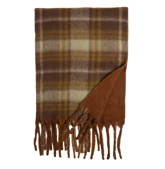 A brown plaid scarf with fringe on one end, displayed against a light gray background. The plaid pattern features shades of brown, tan, and muted yellow, with a solid brown reverse side visible where the corner is folded.