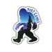A die-cut sticker featuring a Bigfoot silhouette filled with a blue and purple mountain-and-trees landscape, with the words “PORT GAMBLE” in blue arched over the top, shown on a plain white background.
