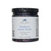 Jar of blueberry lemon thyme preserves with a label on a white background