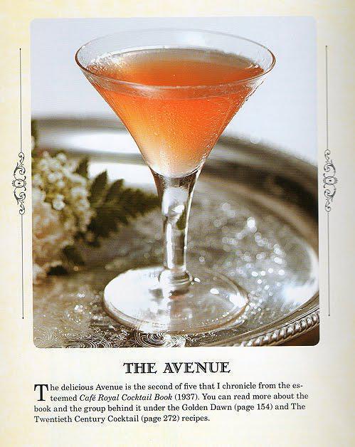 Cocktail in a martini glass on a silver tray with decorative elements