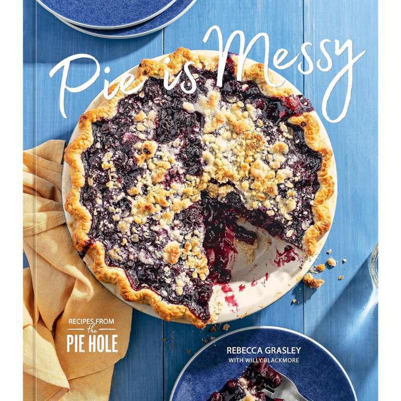 Book cover of 'Pie's Messy' with a blueberry pie on a blue background