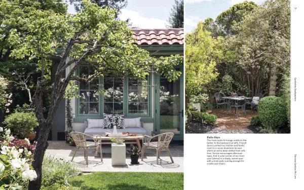 Outdoor patio area with furniture and a small building in the background