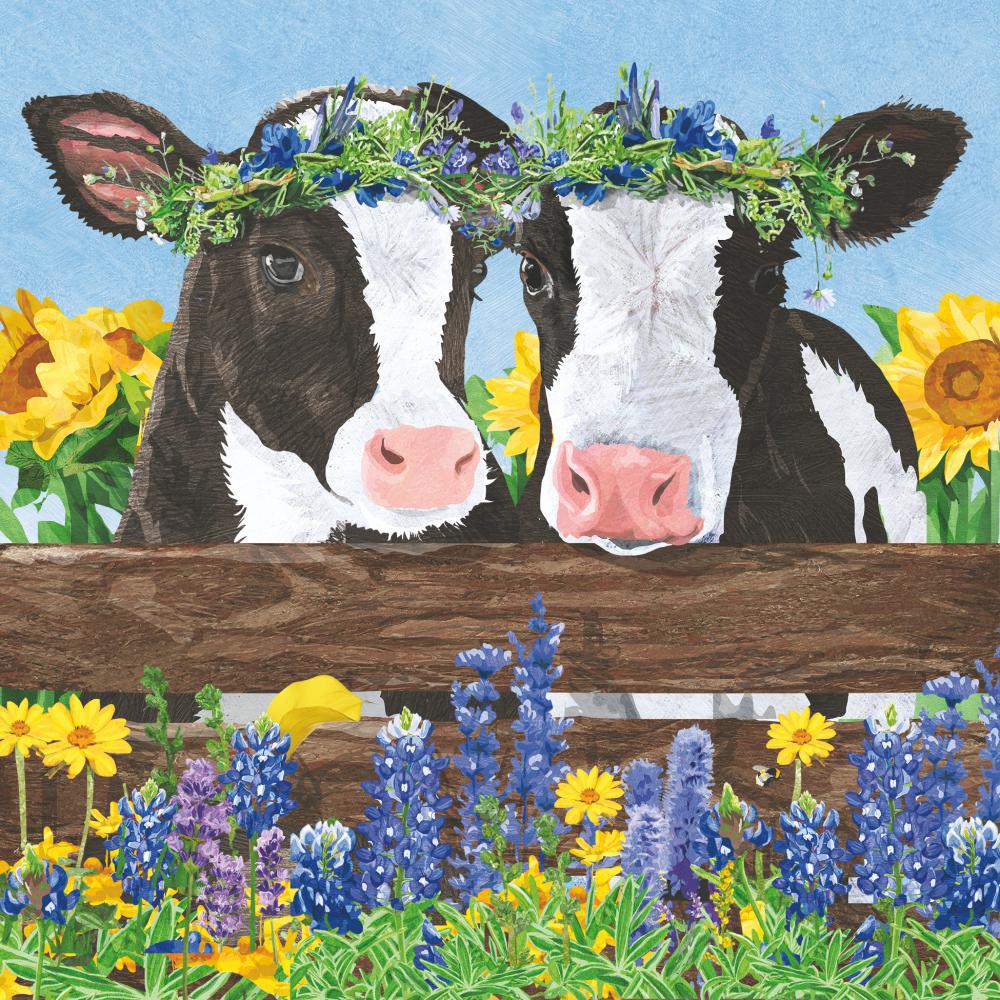 Two cows with flower crowns on a wooden fence with flowers in the background