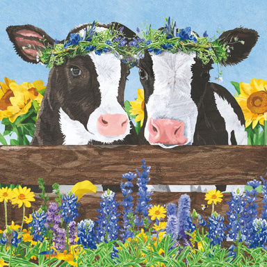 Two cows with flower crowns on a wooden fence with flowers in the background
