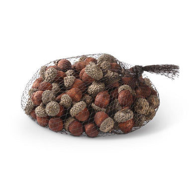 Bag of acorns and pinecones on a white background