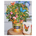 Decorative flower arrangement with butterflies in a honey-themed container, accompanied by a matching card.