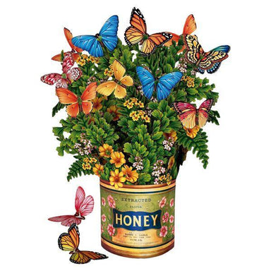 Decorative arrangement with flowers and butterflies on a vintage honey can background