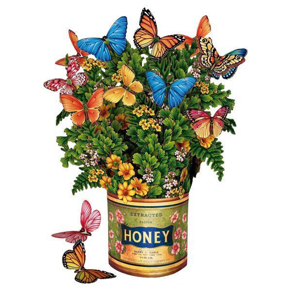 Decorative arrangement with flowers and butterflies on a vintage honey can background