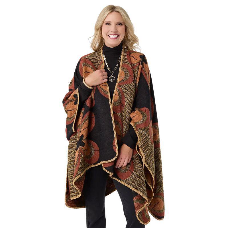 Woman wearing a patterned poncho on a white background