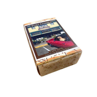 Bar of soap with a decorative label featuring a red car and building on a white background