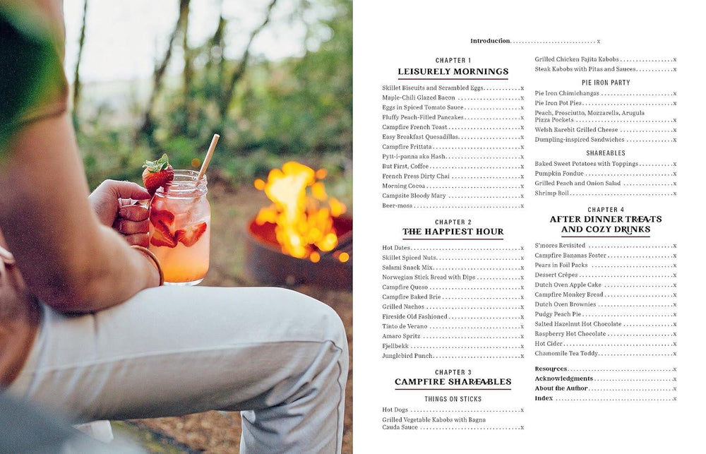 Person holding a cocktail by a campfire with a menu on the right side.