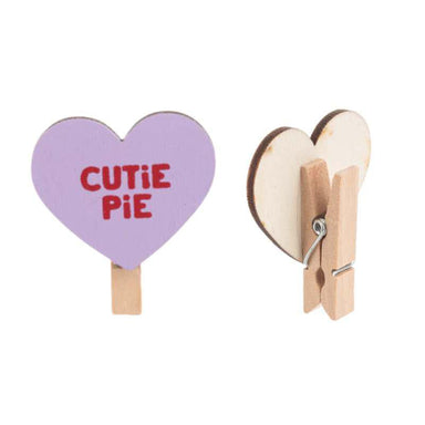 Heart-shaped clip with 'CUTIE PIE' text on a white background