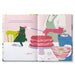 Illustrated book open to a page with a cake and kitchen scene