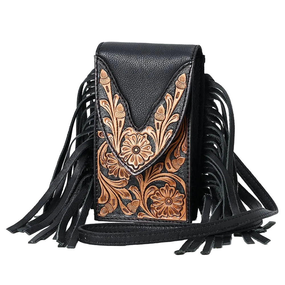 Black leather handbag with floral tooled design and black fringes on a white background