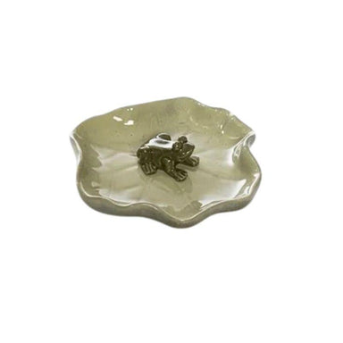Ceramic dish with a frog design on a white background