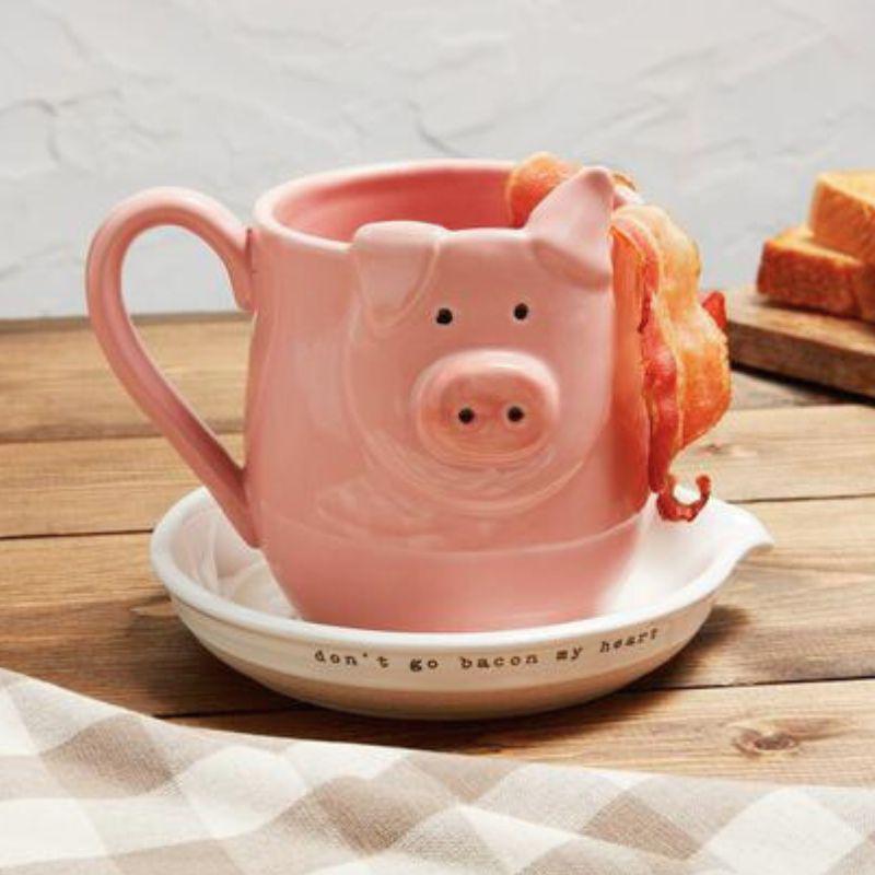 Pink pig-shaped mug with bacon on a wooden table