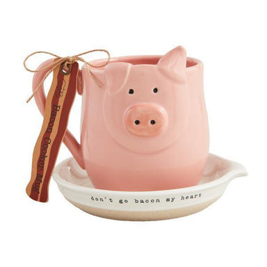 Pink pig-shaped mug with a small dish and 'don't go bacon my heart' text on a white background