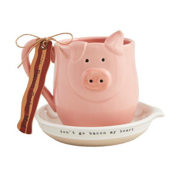 Pink pig-shaped mug with a small dish and 'don't go bacon my heart' text on a white background
